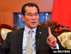 FILE - China's Ambassador to Sweden Gui Congyou speaks in Stockholm, Sweden, Nov 15, 2019.