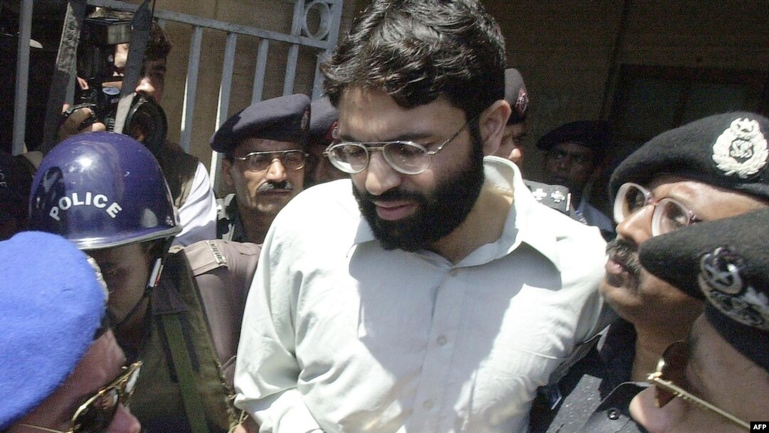FILE - Pakistani police escort Ahmed Omar Saeed Sheikh, who was convicted in the 2002 killing of American journalist Daniel Pearl, as he exits a court in Karachi, Pakistan, March 29, 2002.
