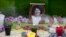 FILE - A picture of Berta Caceres sits on an altar in her honor during a demonstration outside Honduras' embassy in Mexico City, June 15, 2016. 