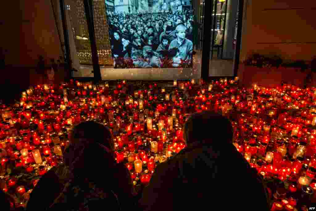 People place candles at a memorial to commemorate the 30th anniversary of the so-called Velvet Revolution in Prague, Czech Republic. The peaceful revolution toppled the Communist regime in former Czechoslovakia 30 years ago.
