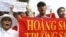 FILE - Vietnamese protesters carry a banner with a Vietnamese slogan reading, "Paracel islands and Spratly islands belong to Vietnam," during a protest demanding China to stay out of their waters, in Hanoi, Vietnam.
