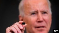 WASHINGTON, DC - FEBRUARY 24: U.S. President Joe Biden holds a semiconductor during his remarks before signing an Executive Order on the economy in the State Dining Room of the White House on February 24, 2021 in Washington, DC. Doug Mills/Pool…