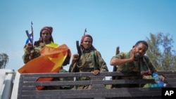 FILE - Tigrayan forces ride in a truck after taking control of Mekele, in the Tigray region of northern Ethiopia, June 29, 2021. 