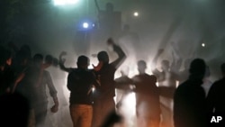 Egyptian voters protest in front of a anti-riot vehicle as they claim they were prevented from casting their votes in Damas, near El Dakahlia, Egypt, 05 Dec 2010