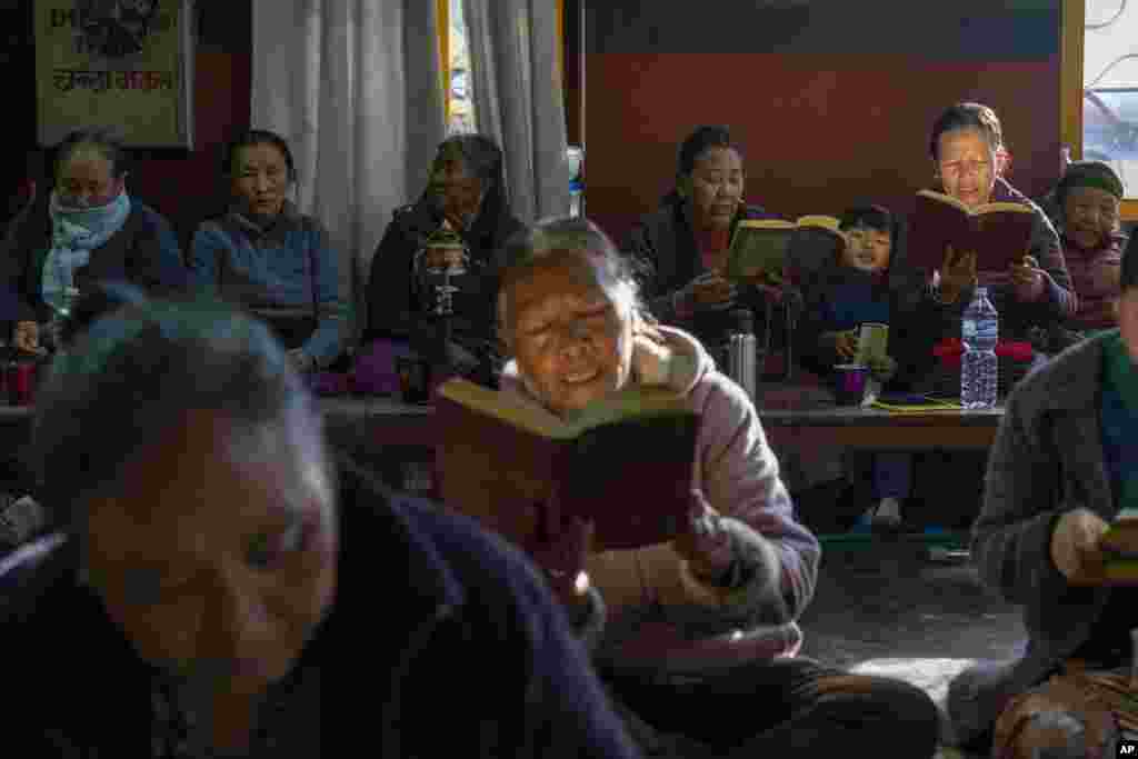 Tibetans gather to offer prayers in remembrance of those who lost their lives in the recent earthquake, at a Tibetan camp in Lalitpur, Nepal. (AP Photo/Niranjan Shrestha)