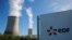 FILE — The logo of Electricite de France, EDF — one of the companies vying to open the first nuclear power plant in Ghana — is seen in front of cooling towers at the entrance of the nuclear power plant site, in Civaux, France, on March 19, 2024. 