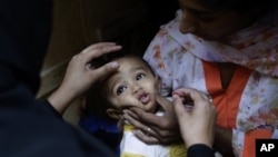 Child receives a polio vaccine in Islamabad, Pakistan, Oct. 16, 2012.