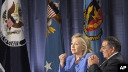 Secretary of State Hillary Rodham Clinton, accompanied by Defense Secretary Leon Panetta, speaks during an event at the National Defense University in Washington, Aug. 16, 2011.