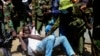 Police arrest a protester who has chained himself during protests against abductions in Nairobi, Dec. 30, 2024. 