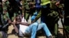 Police arrest a protester who has chained himself during protests against abductions in Nairobi, Dec. 30, 2024. 