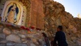 (FILE) Faithful pray at a Virgin of Guadalupe altar at Mount Cristo Rey, on the border between the United States and Mexico, in Sunland Park, New Mexico, U.S., November 23, 2024.