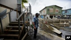 Juana Matos resident Hector Rosa walks through a flooded area after the passing of Hurricane Maria, in Puerto Rico, Wednesday, September 27, 2017. Since the devastating impact of said hurricane, the supply line of goods in general was interrupted in the US territory, causing endless rows in gas stations and comercial centers.