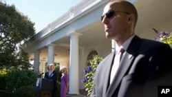FILE - A Secret Service Agent stands guard as then-Vice President Joe Biden speaks in the Rose Garden of the White House in Washington, Oct. 21, 2015.