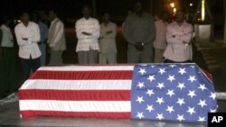 Sudanese men look at the flag-draped coffin of U.S. diplomat John Granville, who worked for the U.S. Agency for International Development. (file)