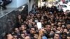 FILE - Palestinians line up to receive monetary aid from Qatar's government for poor families, in Gaza City, Palestinian territories, Nov. 10, 2018. 