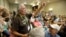 FILE - Willie Grayeyes, of the Utah Dine Bikeyah, raises his hand as he is recognized during a news conference, in Salt Lake City, Aug. 4, 2016. Navajo Nation leaders are protesting a Utah county's investigation into a Navajo candidate's residency, saying it's an attempt to disqualify a Native contender after a federal judge decided voting districts discriminated against Navajos.