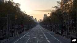 An avenue is seen empty in Barcelona, Spain, Sunday, March 15, 2020. 