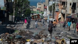 Residents evacuate Poste Marchands in Port-au-Prince, Haiti on December 9, 2024, after gangs took control of the region on December 7. Nearly 200 people in Haiti were killed in brutal weekend violence reportedly orchestrated against voodoo practitioners.