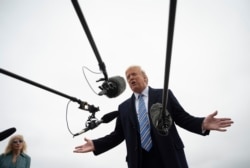 President Donald Trump speaks to the press before boarding Air Force One in Andrews Air Force Base, Md., March 28, 2020.