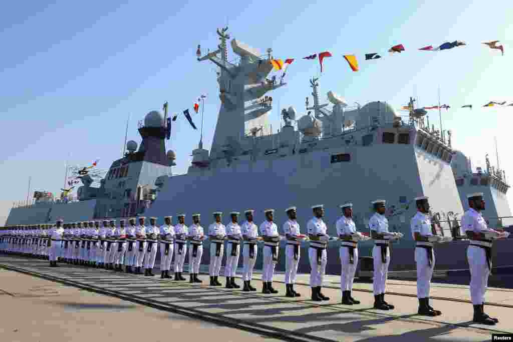 Pakistan Navy&#39;s servicemen stand as they carry national flags of participating countries during the opening ceremony of Pakistan Navy&#39;s 9th Multinational Maritime Exercise AMAN-25, under the slogan &quot;Together for Peace,&quot; in Karachi, Pakistan.