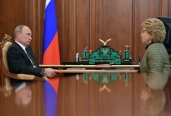 FILE - Russian President Vladimir Putin, left, meets with the speaker of the Federation Council, upper parliament chamber Valentina Matviyenko at the Novo-Ogaryovo residence, outside Moscow, Russia, June 26, 2017.