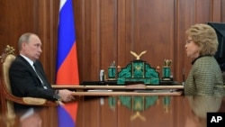 FILE - Russian President Vladimir Putin, left, meets with the speaker of the Federation Council, upper parliament chamber Valentina Matviyenko at the Novo-Ogaryovo residence, outside Moscow, Russia, June 26, 2017.