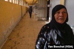 A woman searches for information on her missing loved one at Sednaya Prison in Damascus, Syria, on Dec. 16, 2024.