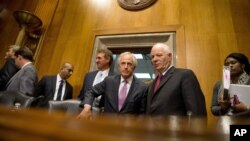 FILE - Senate Foreign Relations Committee Chairman Sen. Bob Corker, R-Tenn., center, speaks with the committee's ranking member Sen. Ben Cardin, D-Md., on Capitol Hill in Washington, April 14, 2015.