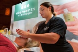 Adrianna DeJesus, right, of Elements Massage in Englewood, Colo., in New York, Aug. 7, 2018.