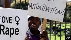 Activists and women's rights advocates, demonstrate outside the court downtown outside the high court in downtown Johannesburg, South Africa. South Africa has one of the highest rates of rape in the world, and women's rights groups here say statistics show only one of nine women raped in South Africa reports the crime. (AP Photo/Themba Hadebe)
