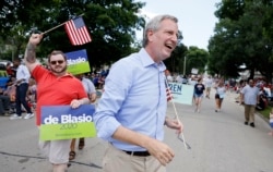 FILE - Democratic presidential candidate New York Mayor Bill DeBlasio walks in the Independence Fourth of July parade, July 4, 2019, in Independence, Iowa.