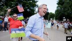 FILE - Democratic presidential candidate New York Mayor Bill DeBlasio walks in the Independence Fourth of July parade, July 4, 2019, in Independence, Iowa. 