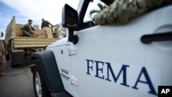 Department of Homeland Security personnel deliver supplies to Santa Ana community residents in the aftermath of Hurricane Maria in Guayama, Puerto Rico, Thursday, Oct. 5, 2017.