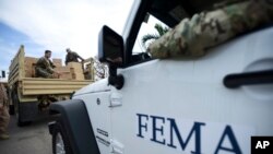 FILE - Department of Homeland Security personnel deliver supplies to Santa Ana community residents in the aftermath of Hurricane Maria in Guayama, Puerto Rico, Thursday, Oct. 5, 2017.