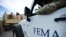 FILE - Department of Homeland Security personnel deliver supplies to Santa Ana community residents in the aftermath of Hurricane Maria in Guayama, Puerto Rico, Thursday, Oct. 5, 2017.