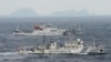 An aerial photo shows Chinese marine surveillance ships Haijian No. 49 (front) and Haijian No.50 cruising in the East China Sea, as the islands known as Senkaku isles in Japan and Diaoyu islands, April 23, 2013.