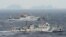An aerial photo shows Chinese marine surveillance ships Haijian No. 49 (front) and Haijian No.50 cruising in the East China Sea, as the islands known as Senkaku isles in Japan and Diaoyu islands, April 23, 2013.