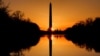 The sun rises behind the Washington Monument on an early spring morning in Washington, D.C.