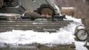 An Ukrainian serviceman peers from an armored personnel carrier near a front-line position in the Luhansk area, eastern Ukraine, Jan. 28, 2022.