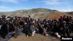 Displaced Afghan villagers gather near the site of a landslide that occurred May 2 at the Argo district in Badakhshan province, May 5, 2014.