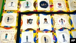 A section of two hand crafted quilts adorned with more than 115 cross-stitched portraits honoring African-Americans who lost their lives to racial violence, on display at the Margaret Walker Center on the Jackson State University campus, Nov. 30, 2021.