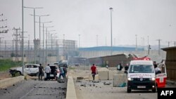 FILE - An ambulance is parked at the scene of an Israeli air strike at the Erez crossing between Israel and the northern Gaza Strip on October 7, 2023.