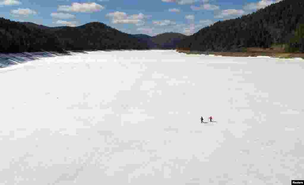 Local residents make their daily trip on spring ice across the Yenisei River to the isolated Siberian Khmelniki village, outside Krasnoyarsk, Russia, April 22, 2019.