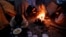 Migrants eat around a fire at a camp in Velika Kladusa, Bosnia, close to the border to Croatia, Nov. 18, 2018. 