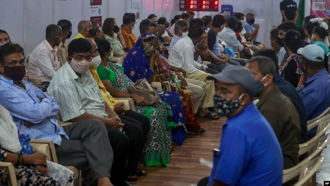 People wait to receive a COVID-19 vaccine at a vaccination site in Mumbai, India, April 18, 2021.