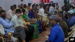 People wait to receive a COVID-19 vaccine at a vaccination site in Mumbai, India, April 18, 2021.