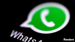 FILE - The WhatsApp messaging application is seen on a phone screen. 