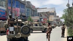 Afghan security personnel arrive at the site where gunmen attacked, in Kabul, Afghanistan, May 12, 2020.