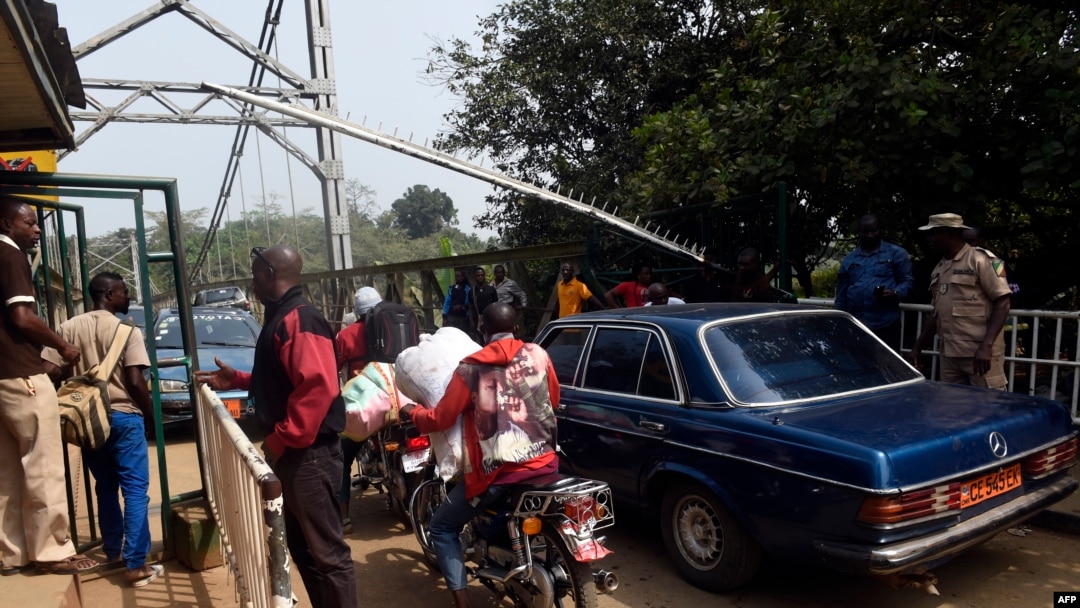 FILE - Security guards check vehicles leaving Nigeria for Cameroon at a border checkpoint in Mfum, in Cross Rivers State, southeast Nigeria, Feb. 1, 2018. Cameroon is securing borders with C.A.R and Nigeria amid renewed threats.