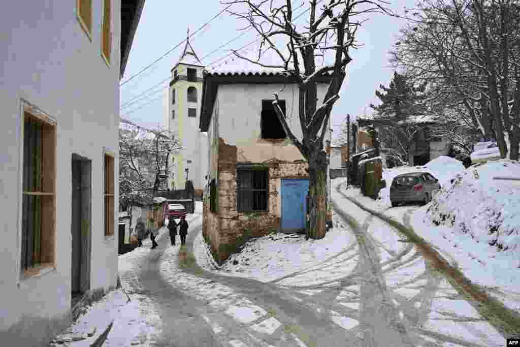 Christian faithful leave the Saint Nicholas church after attending a Christmas mass in the small town of Janjeve, Kosovo, during Christmas celebrations, Dec. 25, 2024.